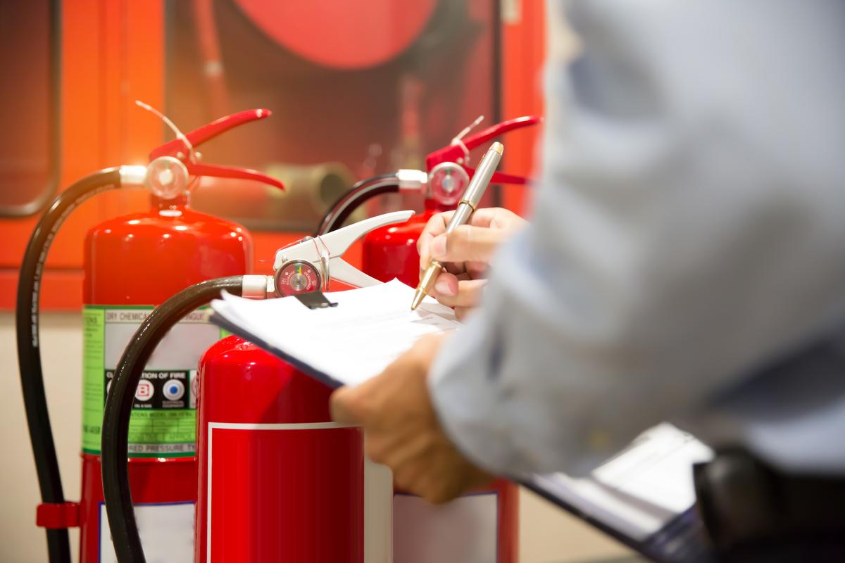 Professional engineers checking fire extinguishers